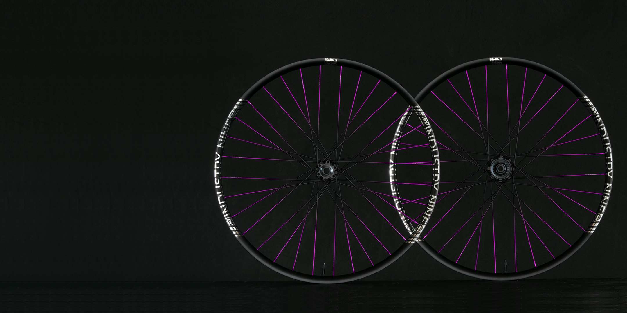 Images of two Dirt jump wheels with black to purple faded spokes